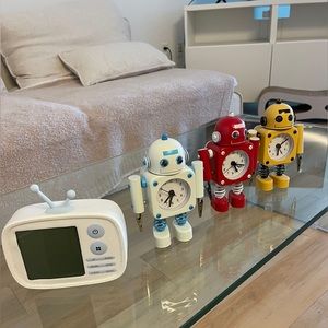 Three robot clocks and one tv clock for a price of one